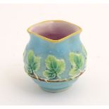 A George Jones style majolica pot with banded vine leaf decoration and a lozenge shaped rim. Approx.