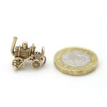 A 9ct gold pedant charm formed as a steam engine.