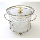 A late 19thC / early 20thC cut glass biscuit barrel with silver plated mounts and lid,