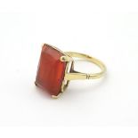 An 18ct gold ring set with orange stone possibly a fire opal.