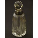 A small glass scent/perfume bottle, with cut floral decoration and silver collar,