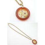 An Oriental orange jade pendant set with Chinese Dragon and fire bird decoration to centre having