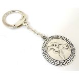 A silver key ring with horse to centre within a greek key border CONDITION: Please