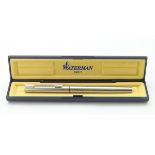 A cased fountain pen by Waterman, Paris, with steel finish. 5 3/8" long.