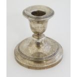 A silver candlestick hallmarked Birmingham 1921 maker Sanders & Mckenzie 4" high