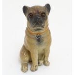 A 19thC painted terracotta model of a seated dog with glass inset eyes. Approx. 4 1/2" high.