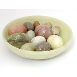 A turned onyx bowl, together with 12 egg shaped hand warmers of various sizes,