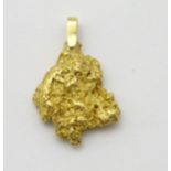 A yellow metal pendant formed as a gold nugget. 1 ¼” long.