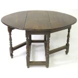An 18thC oak gateleg table with drop leaves to each side,