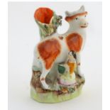 A 19thC flatback Staffordshire Pottery spill vase formed as a milk maid milking a cow. Approx.