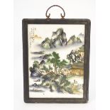 A Small Chinese ceramic screen in wooden surround, depicting figures,