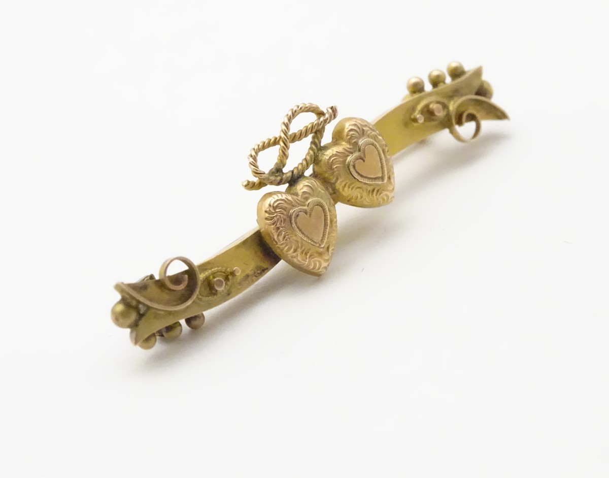A Victorian 9ct gold bar brooch set with twin hearts, 1 ¾” wide. - Image 5 of 6