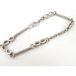A silver bracelet with link and twist decoration. 7” long.