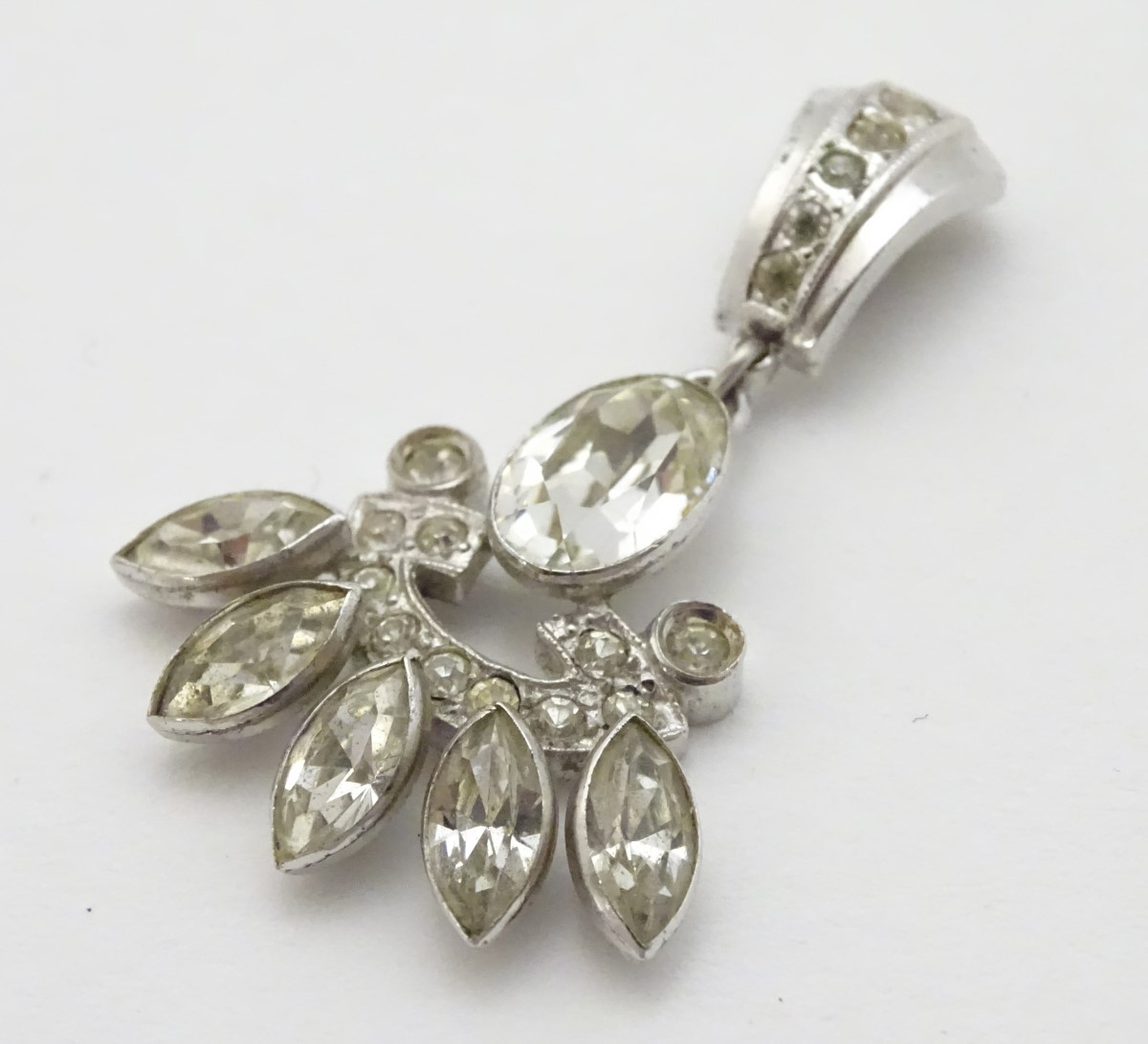 A white metal pendant set with paste stones 1 3/54" long CONDITION: Please Note -