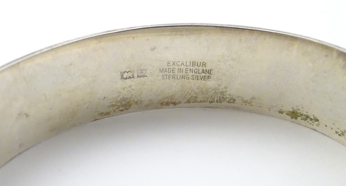 A hallmarked silver bangle formed ' Excalibur' bracelet with engraved decoration. - Image 2 of 5