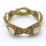 A silver gilt bracelet with filigree decoration and set with rose quartz CONDITION: