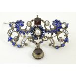 A late 19thC / early 20thC Baroque brooch set with garnet drop, blister pearls,