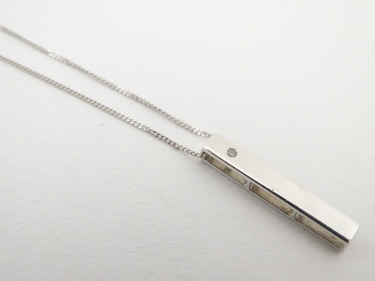 A 9ct white gold necklace and pendant, the pendant set with diamond. Approx.