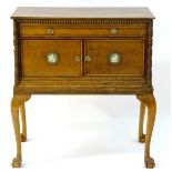 A late 19thC / early 20thC walnut cabinet on stand, having a rectangular top above a moulded frieze,