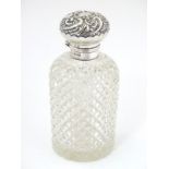 A hobnail cut glass scent / perfume bottle with silver mount and lid.