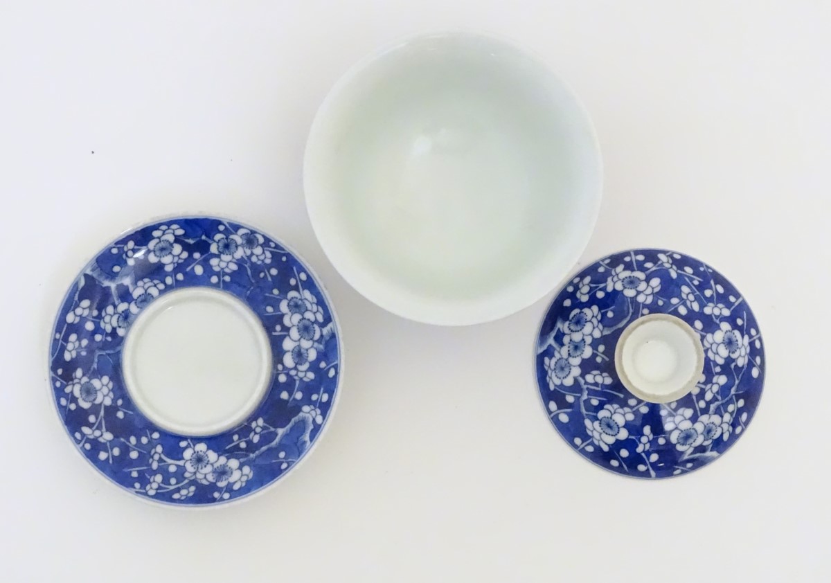 A Chinese blue and white tea bowl, lid and saucer, decorated with cherry blossom. - Image 2 of 5