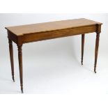 A mid 19thC mahogany serving table with an inverted break front top and standing on turned tapering