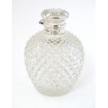 A glass scent bottle with hobnail cut decoration with silver mounts and top hallmarked Sheffield