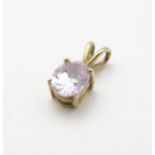 A 9ct gold pendant set with facet oval amethyst, 1 ½” long.