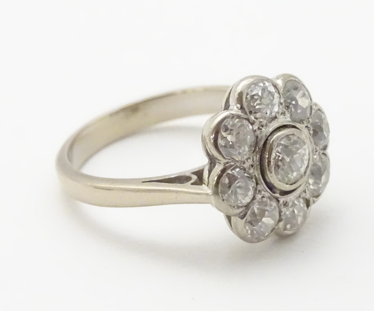 An 18ct white gold ring set with central old cut diamond bordered by 8 further diamonds in a daisy - Image 5 of 8