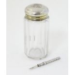 A glass dressing table jar with silver top hallmarked London 1882 maker FF.