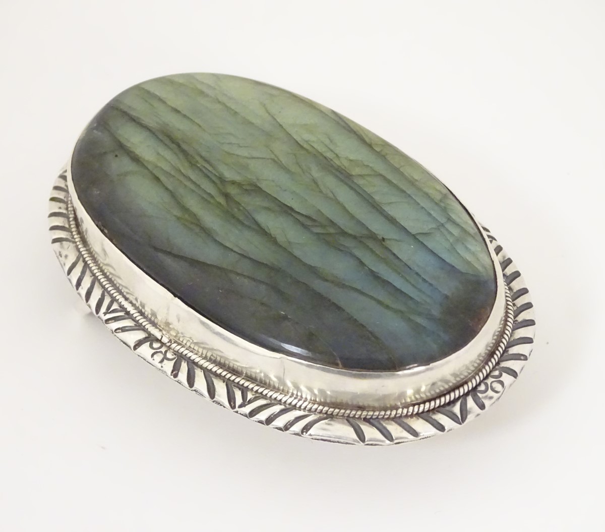 A buckle set with large labradorite cabochon to centre.