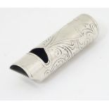 A silver whistle with acanthus scroll decoration 2 1/2" long CONDITION: Please Note