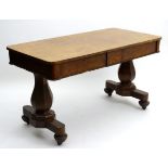 A mid 19thC pollarded oak library table with two frieze drawers above canted supports and base,