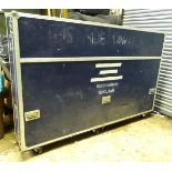 A 20thC Piano transit/freight case, having steel reinforcements, standing on castors, 8' long,