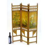 An aesthetic movement folding screen with hand painted panels and turned finial colonnades above