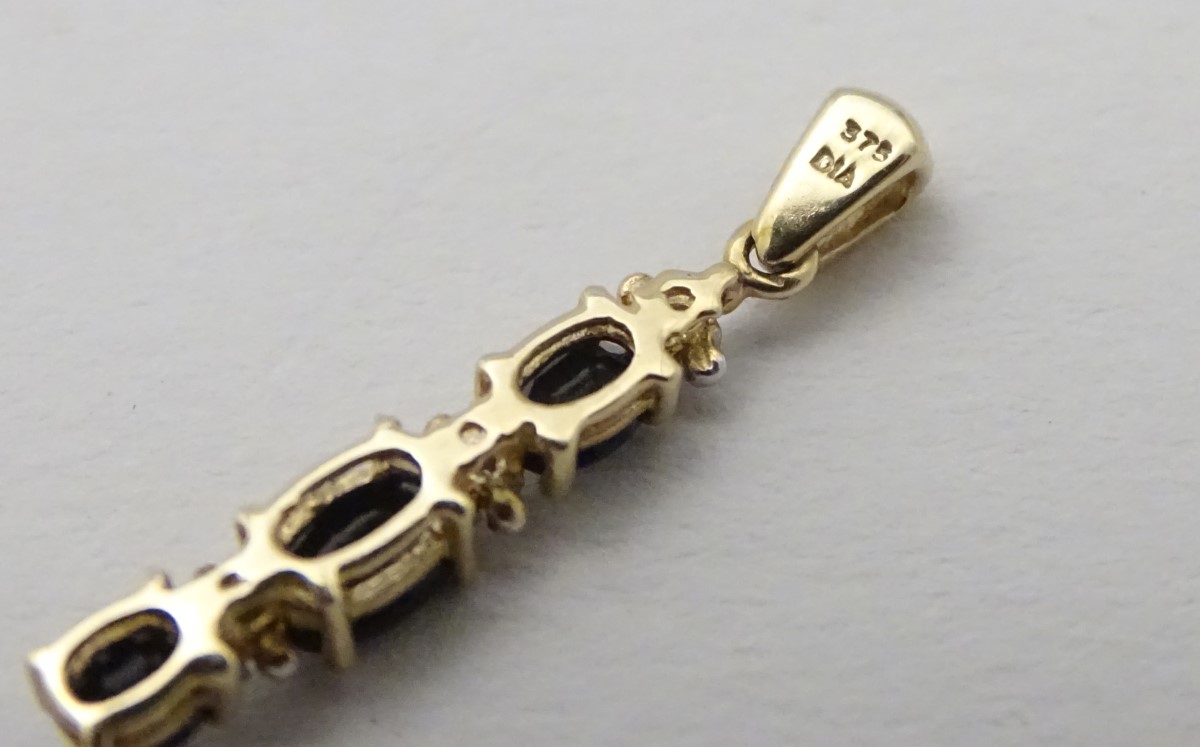 A 9ct gold pendant set with spinels and diamonds, 1” long. - Image 3 of 6