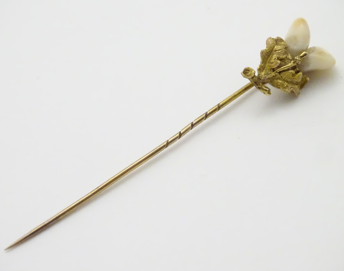 A Victorian Scottish stick pin surmounted by Scottish thistle set with deer's teeth.