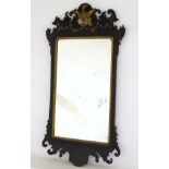 A 19thC ebonised mirror with gilt painted decoration.