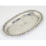 A silver pin dish of oval form. Hallmarked London 1908 maker Mappin & Webb Ltd.