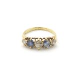 An 18ct gold ring set with diamonds and blue stones CONDITION: Please Note - we do