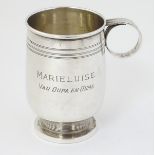 An Art Deco silver Christening mug with banded decoration and ring handle.