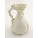 A 19thC Royal Worcester blanc de chine jug with a bulbous body, the handle formed as stylised coral,