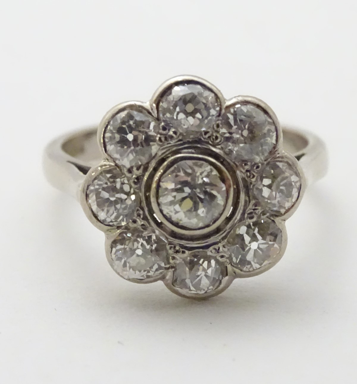 An 18ct white gold ring set with central old cut diamond bordered by 8 further diamonds in a daisy - Image 3 of 8