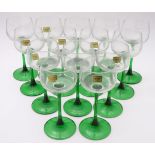 A collection of thirteen mid-20thC retro wine glasses by Luminarc, each with green stem,