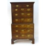 A 19thC chest on chest with a moulded cornice and dentil carved frieze above two small drawers and