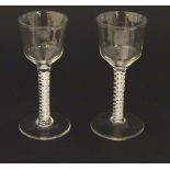 Two 18thC cordial glasses with double air twist stems and spreading foot.