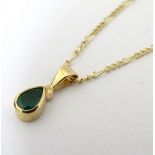 A 9ct gold pendant and chain, the pendant set with emerald.