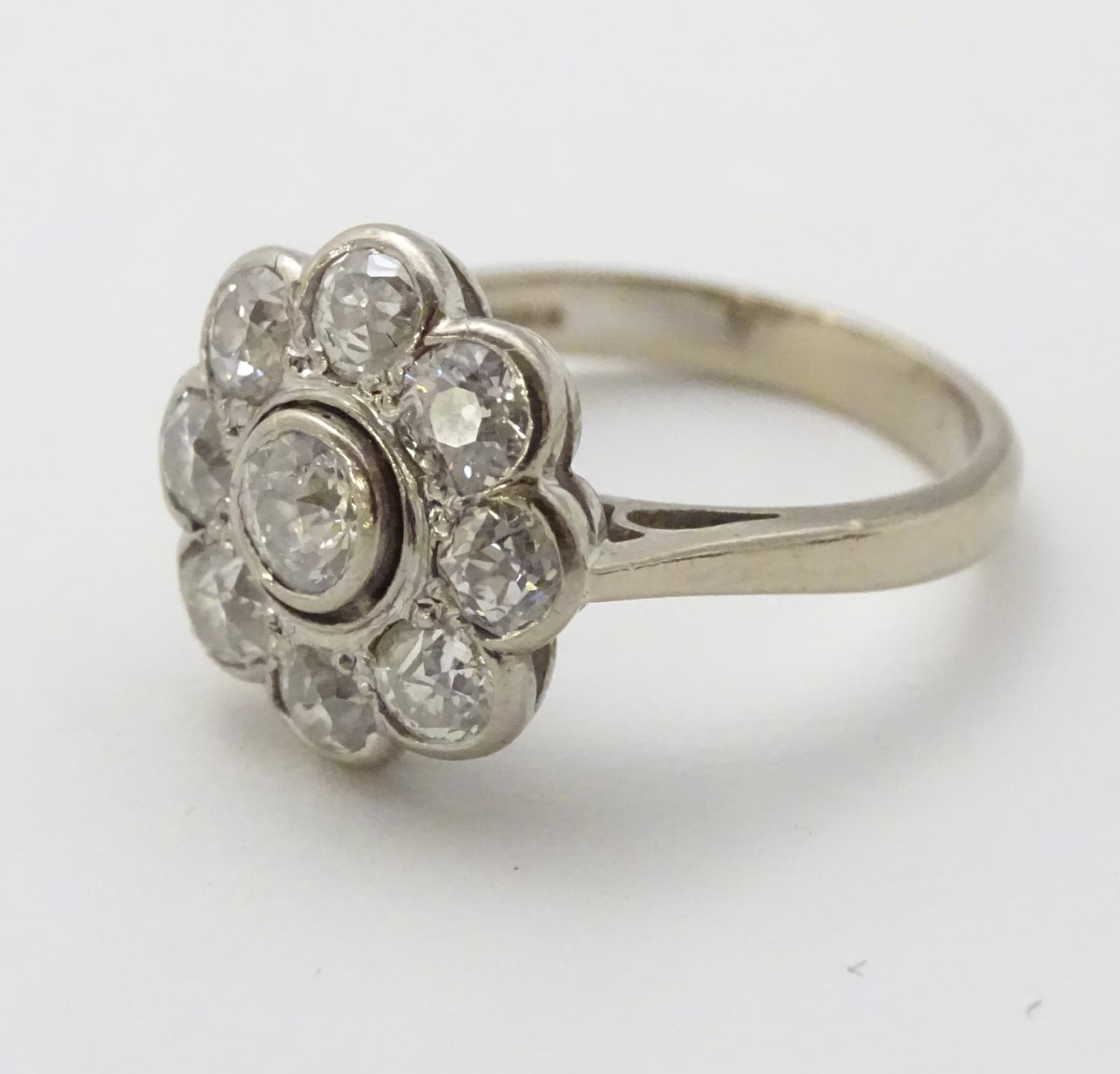 An 18ct white gold ring set with central old cut diamond bordered by 8 further diamonds in a daisy - Image 2 of 8