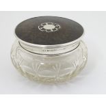 A cut glass dressing table pot with silver and tortoiseshell lid hallmarked Birmingham 1925 maker