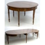 A Victorian mahogany 6-legged extending dining table with a figured frieze,